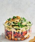 Mexican layered salad with sweet potato and vegetables