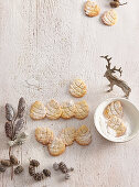 Pine cone-shaped almond biscuits dusted with icing sugar