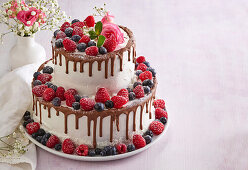 Dripping wedding cake with berries