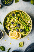 Salad with zucchini, asparagus, cucumber, peas and blueberries