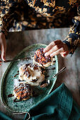 Profiteroles with chocolate sauce and icing sugar