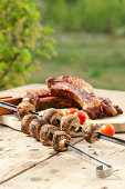 Grilled ribs and mushroom skewers with fresh tomatoes