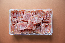 Quince jelly cubes in a plastic box