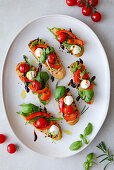 Bruschetta with grilled peppers, tomatoes, mozzarella and balsamic cream