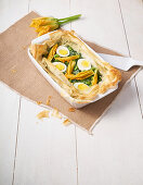 Filo pastry Easter cake with spinach, courgette flowers, broad beans and eggs