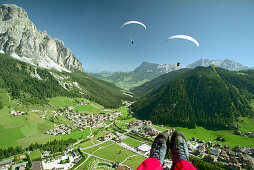 Eine Person beim Gleitschirmfliegen über Corvara, Dolomiten, Alta Badia, Südtirol, Italien