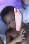 Infant playing with foot, people child