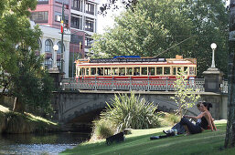 People relaxing, relaxing at river Christchurch, New Zealand