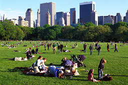 People on the lawn in the sunlight, Central Park, New York, USA, America