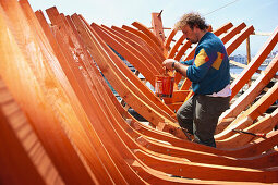 Man building a boat at the harbour of Chania, Crete, Greece, Europe