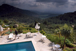 Pool of the Hotel Posada del Maques with view at scenery and thunder clouds, Majorca, Spain