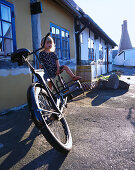 Girl 2-3 years, sitting on bicycle, Arsdale, Bornholm, Denmark