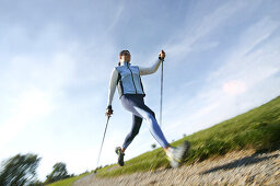 Girl doing nordic walk, wellness sports