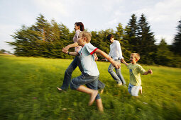 Family running in nature, Family running in nature, Family running through green meadow, Family Nature Lifestyle People