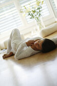 Girl relaxing at home, Girl relaxing at home, Young women sleeping on wooden floor, Home Lifestyle People Wellness