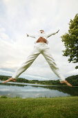 Jumping girl on a lake, Wellness People