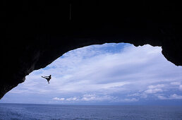 Free climber jumping into sea, Mallorca, Spain