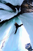 Man climbing in an ice cave, Golden Area, Banff National Park, Canada