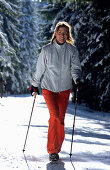 Female nordic walker in snowy wood, Nordic Walking, Muehlviertel, Upper Austria