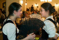 Girls dancing the traditional Kathreintanz dance with fan, Loewenbraeukeller, Munich, Bavaria, Germany