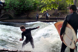 Surfer at Eisbach, small artificial river, English Garden, Munich, Bavaria, Germany