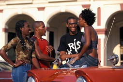 Young people at an old taxi, Havana, Cuba, Caribbean, America