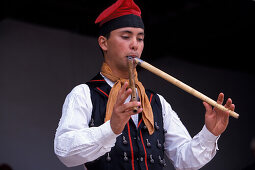 Man wearing traditional clothes, playing the flute, Folklore, Sant Miquel, Ibiza, Balearic Islands, Spain