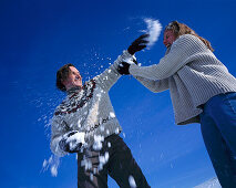 Couple having snowball fight