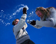 Couple having snowball fight