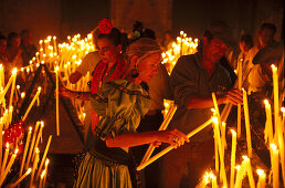 Pilgrims lighting candles, El Rocío, Andalusia, Spain