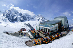 Skiers having a break on the terrace at the Upper Station, Sulden, South Tyrol, Italy