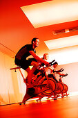 Spinning, Men and woman in gym on exercise bikes, Spinning, leos Sports Club Muenchen