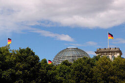 The Reichstag with glass dome and German flags, Berlin, Germany