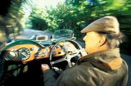 Man driving an Aston Martin, Jersey, Channel Islands, Great Britain