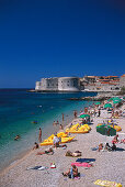 People on the beach in front of the old town of Dubrovnik, Croatia, Europe