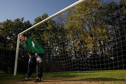 Young goalkeeper waiting for ball
