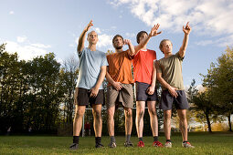 Soccer players awaiting a free kick, Arms stretching high