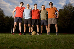 Five young male soccer players in a row