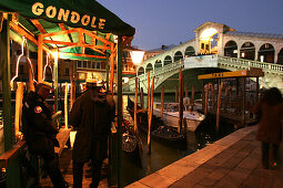 Tree Gondola drivers in front of a gondola renting service, Rialto Bridge, Canale Grande, Venice, Italy