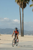 Woman on a racing bike at Venice Beach, California, USA