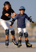 Mother and son inlining skating in Barcelona, Spain