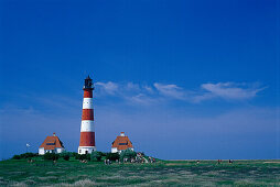 Westerheversand lighthouse and houses in the sunlight, Westerhever, Eiderstedt peninsula, Schleswig Holstein, Germany, Europe