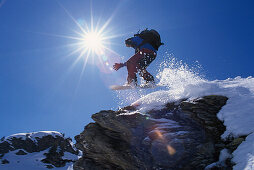 Snowboarder in action, Performing a jump, Hochfuegen, Zillertal, Tyrol, Austria