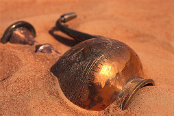 Copper can lying in the sand of the desert, Dubai, United Arab Emirates