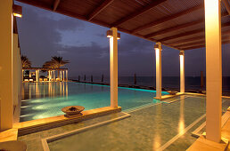 The illuminated Chedi Pool at night, The Chedi Hotel, Muscat, Oman, Middle East, Asia