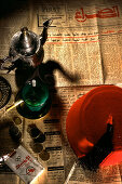 Newspaper, peppermint tea and cigarettes on the table at a teahouse, Fes, Morocco, Africa