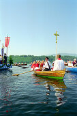 People rowing during a procession on the lake Staffelsee, Murnau, Bavaria, Germany