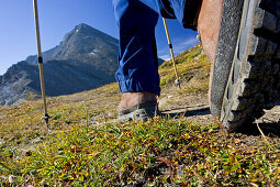 Hiking boots approach a mountain, Engadin, Grisons, Switzerland