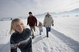 Familie mit zwei Kindern beim Winterspaziergang