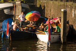 People, Leisure Boats, Brouwersgracht, Jordaan, Young People relaxing in leisure boats on a sunny day, Brouwersgracht, Jordaan, Amsterdam, Holland, Netherlands